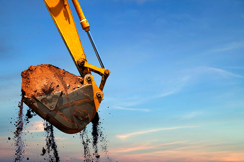 large excavator lifting dirt