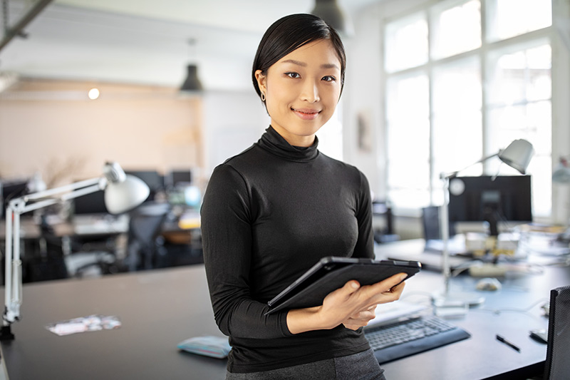 female asian american small business owner in her office