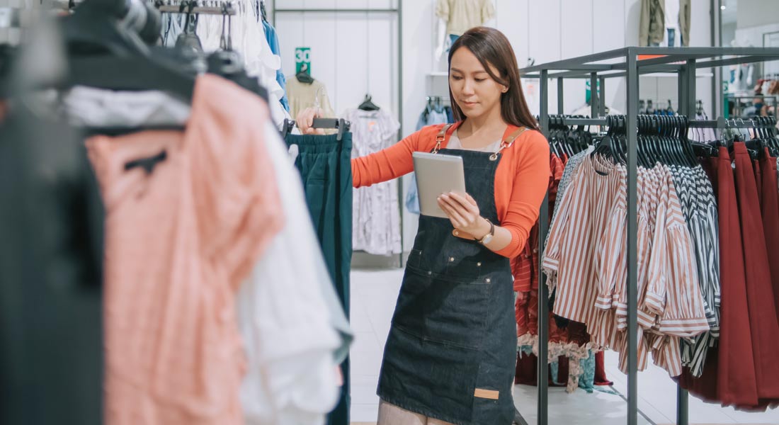 clothing store owner checking inventory, how to manage business inventory