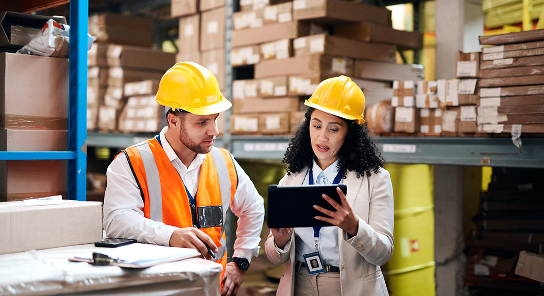 two warehouse workers discussing a task, post-holiday checklist for businesses